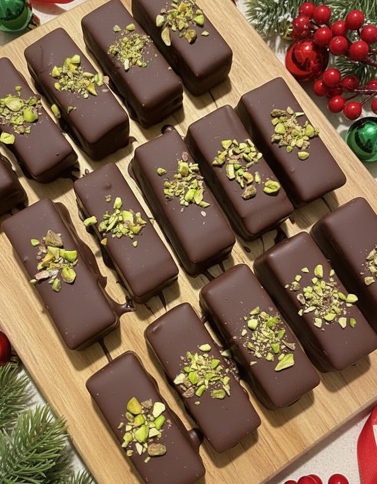 Chocolate bars with pistachio pieces arranged in a grid pattern.